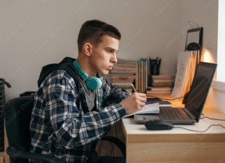 조지아주, 공립 대신 사립· 홈스쿨링 선택하면 6500달러 지원 Teenage boy doing homework using computer sitting by desk in room alone